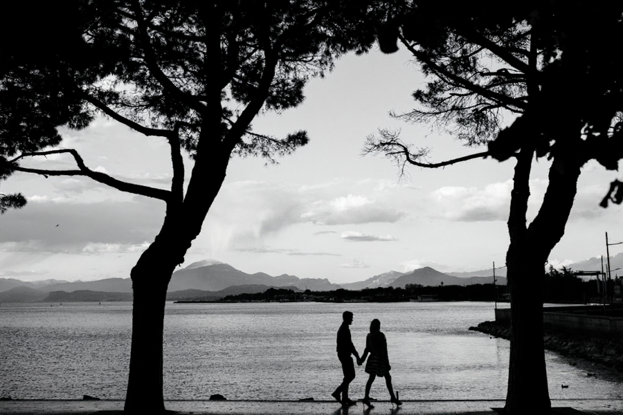 Couple walking by waterfront, experiencing life beyond screens