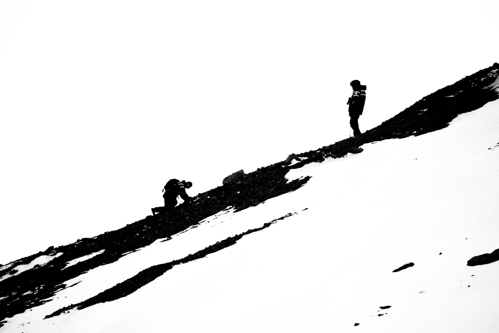 Hikers climbing a snowy mountain, representing overcoming obstacles